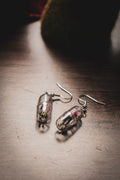 Funky human capsule earrings