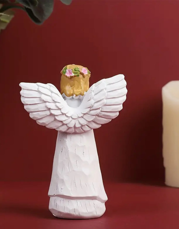 Angel carrying dog figurine