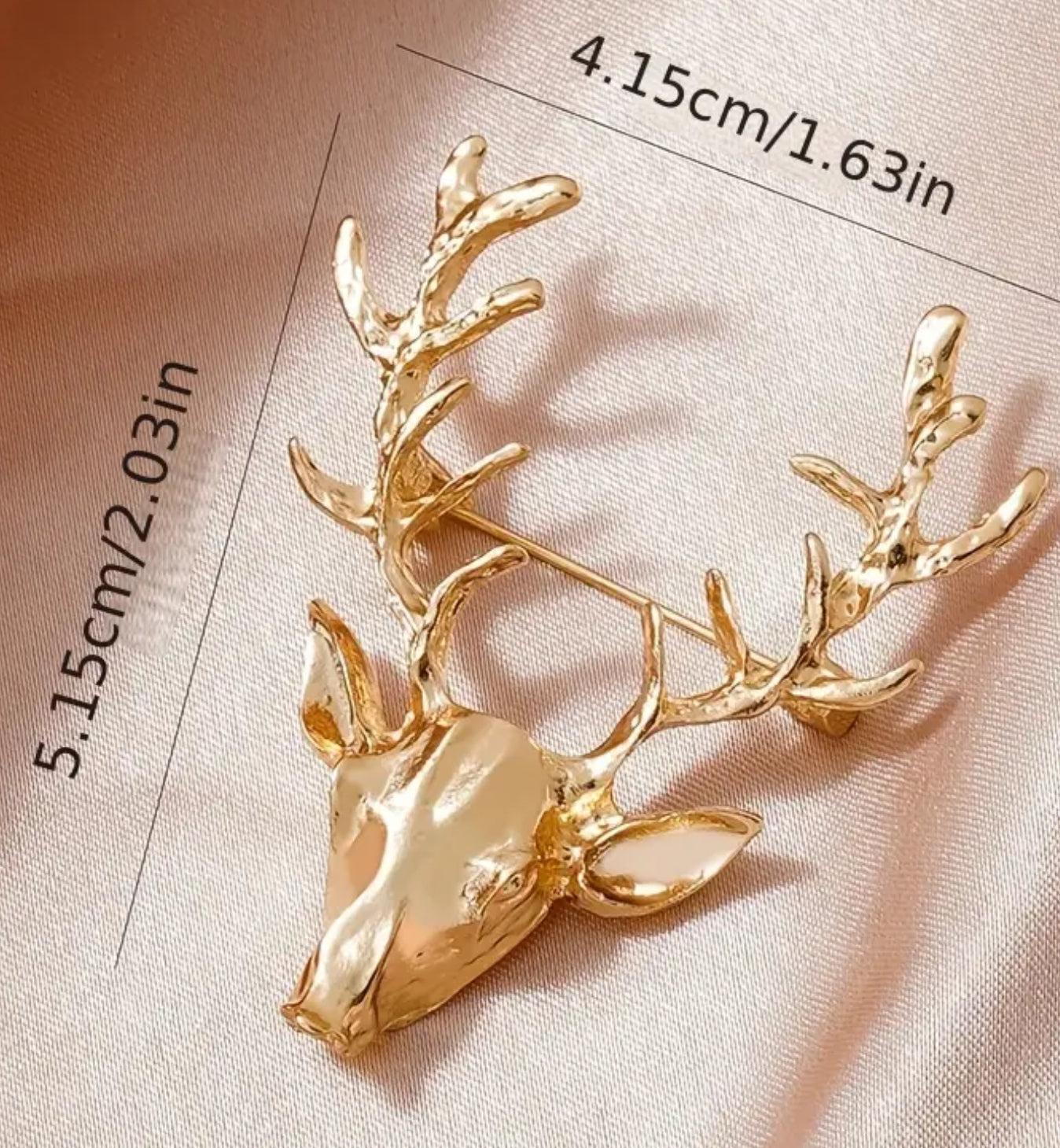 Gold reindeer brooch