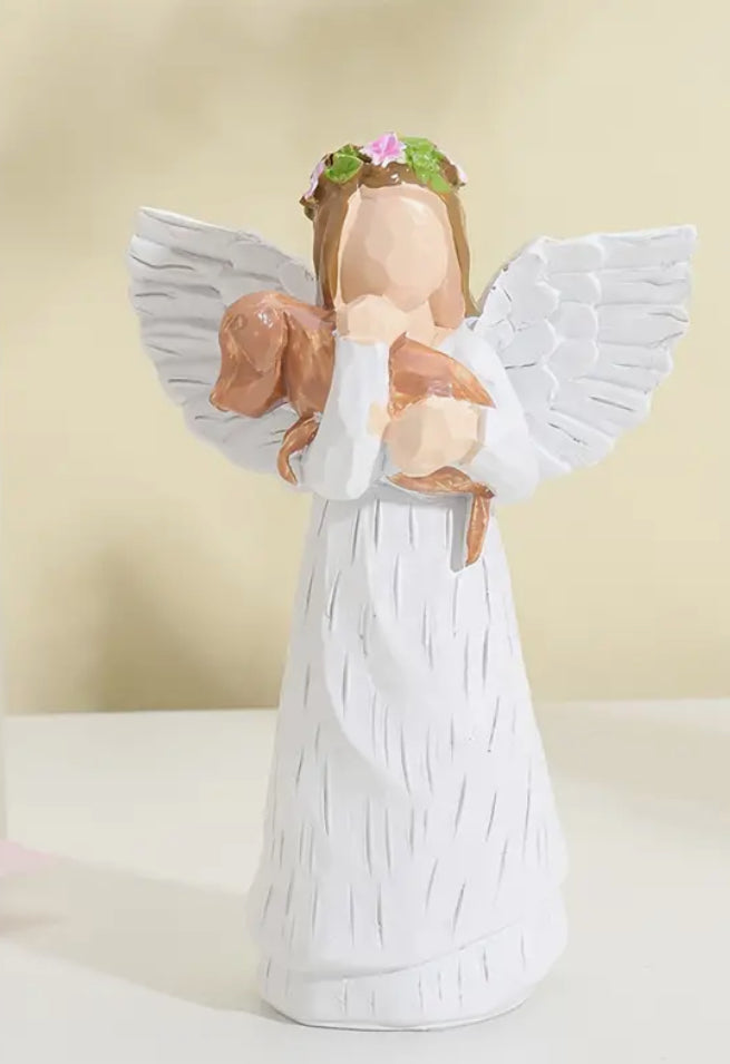 Angel carrying dog figurine