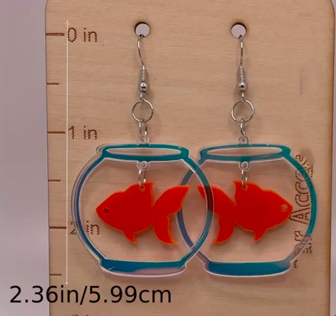 Boucles d'oreilles poisson rouge dans un bol en verre