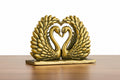 Solid brass swans kissing