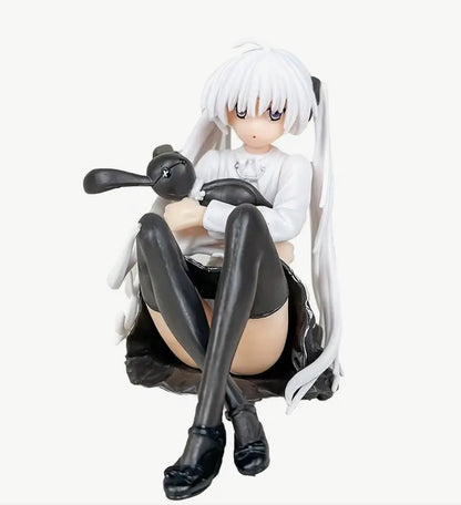 Anime girl sitting with rabbit figurine