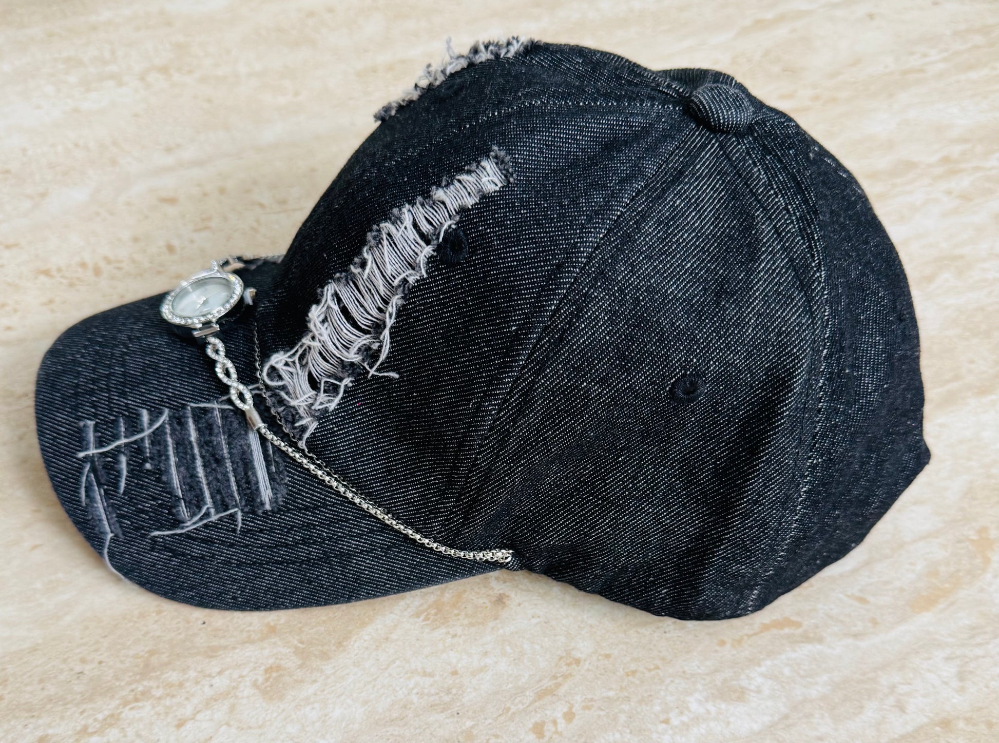 Torn black denim cap