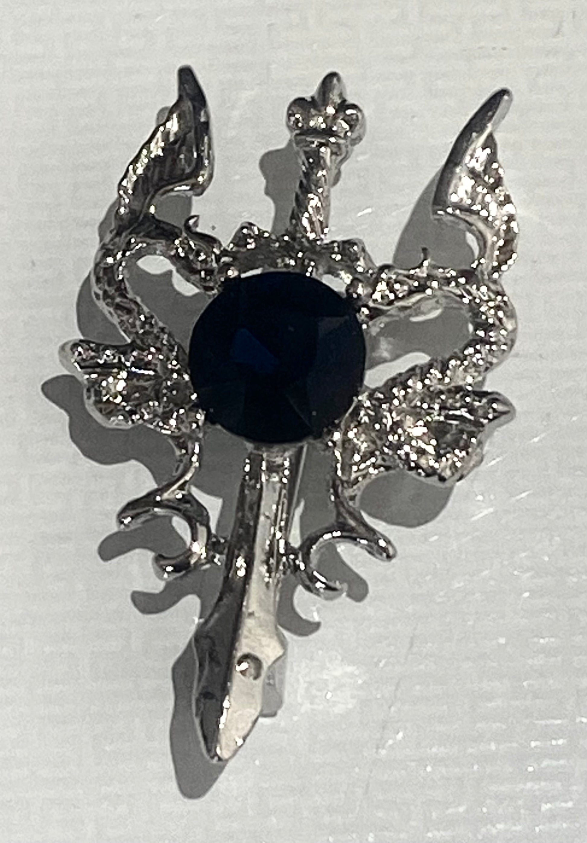 Serpents with sword brooch with blue crystal