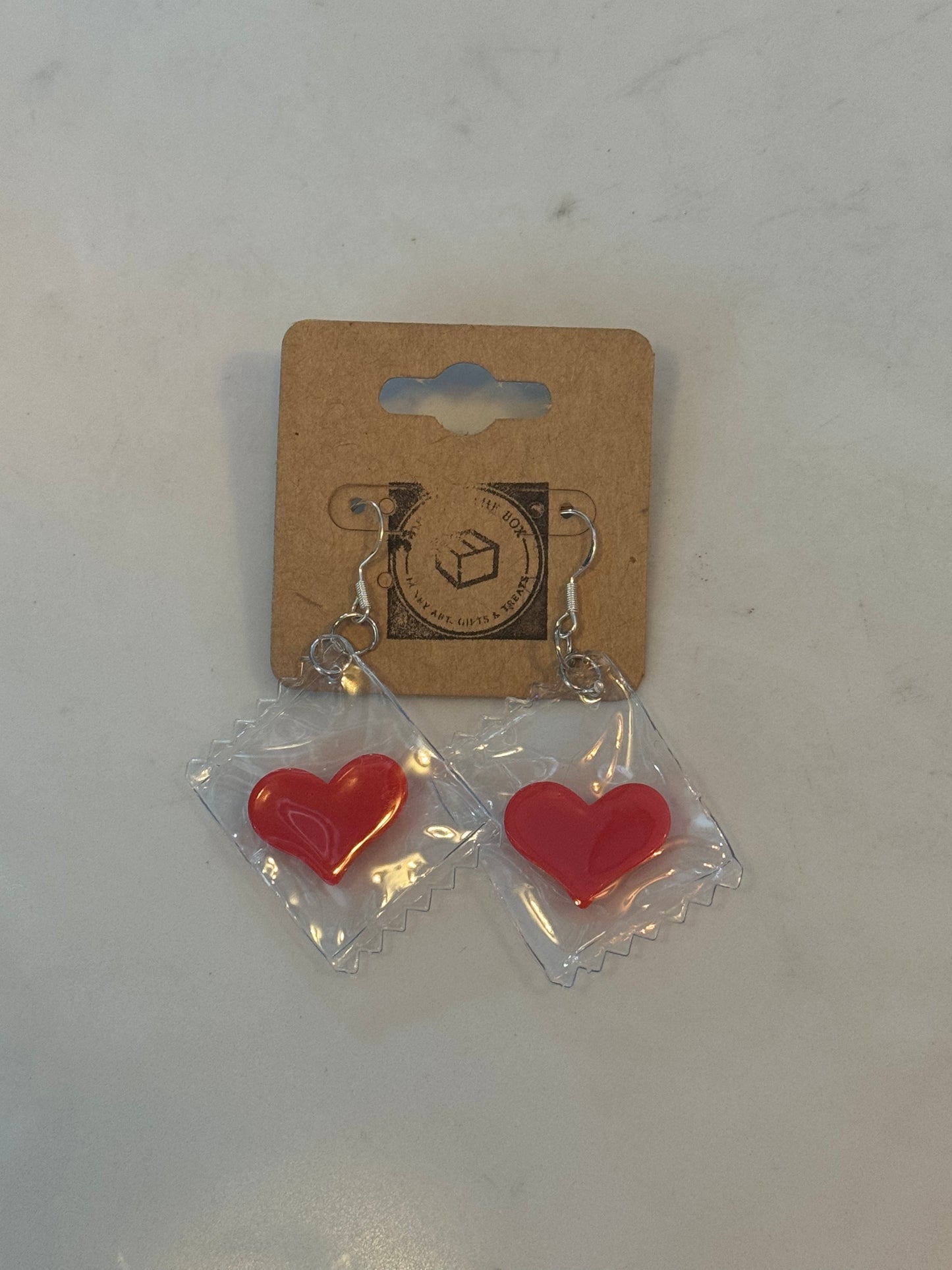 Heart in plastic bag sterling silver earrings