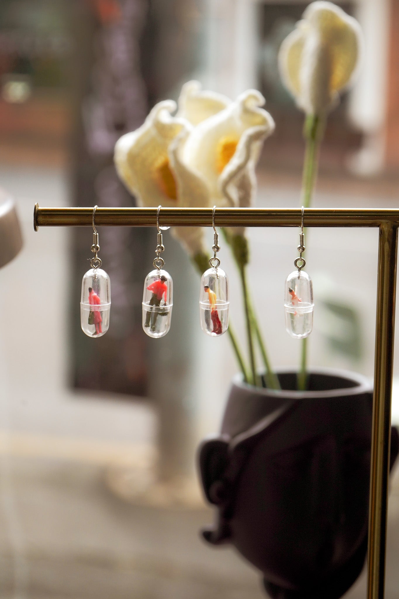 Funky human capsule earrings