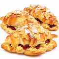 Three almond cherry croissants on white background