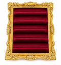 Ornate gold resin frame and burgundy velvet ring display on white background