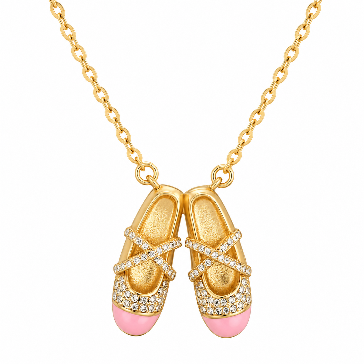 Gold-tone ballet shoes necklace with pink enamel toe caps on white background