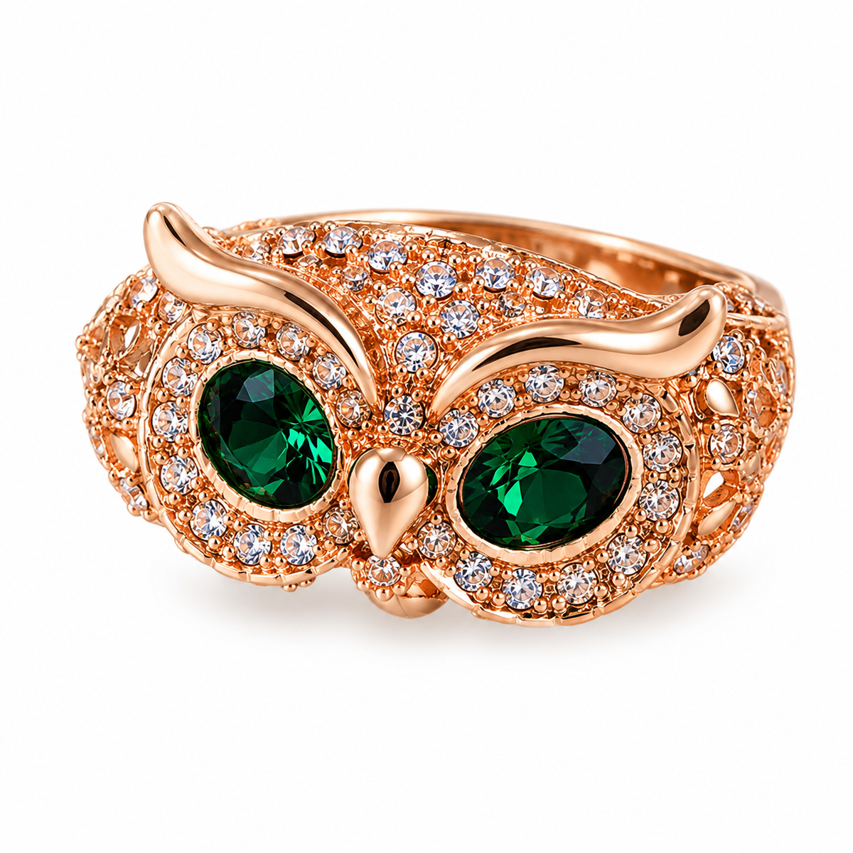 Copper owl ring with green crystal eyes on white background