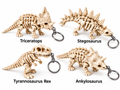 Four dinosaur skeleton keychain designs labelled by dinosaur name