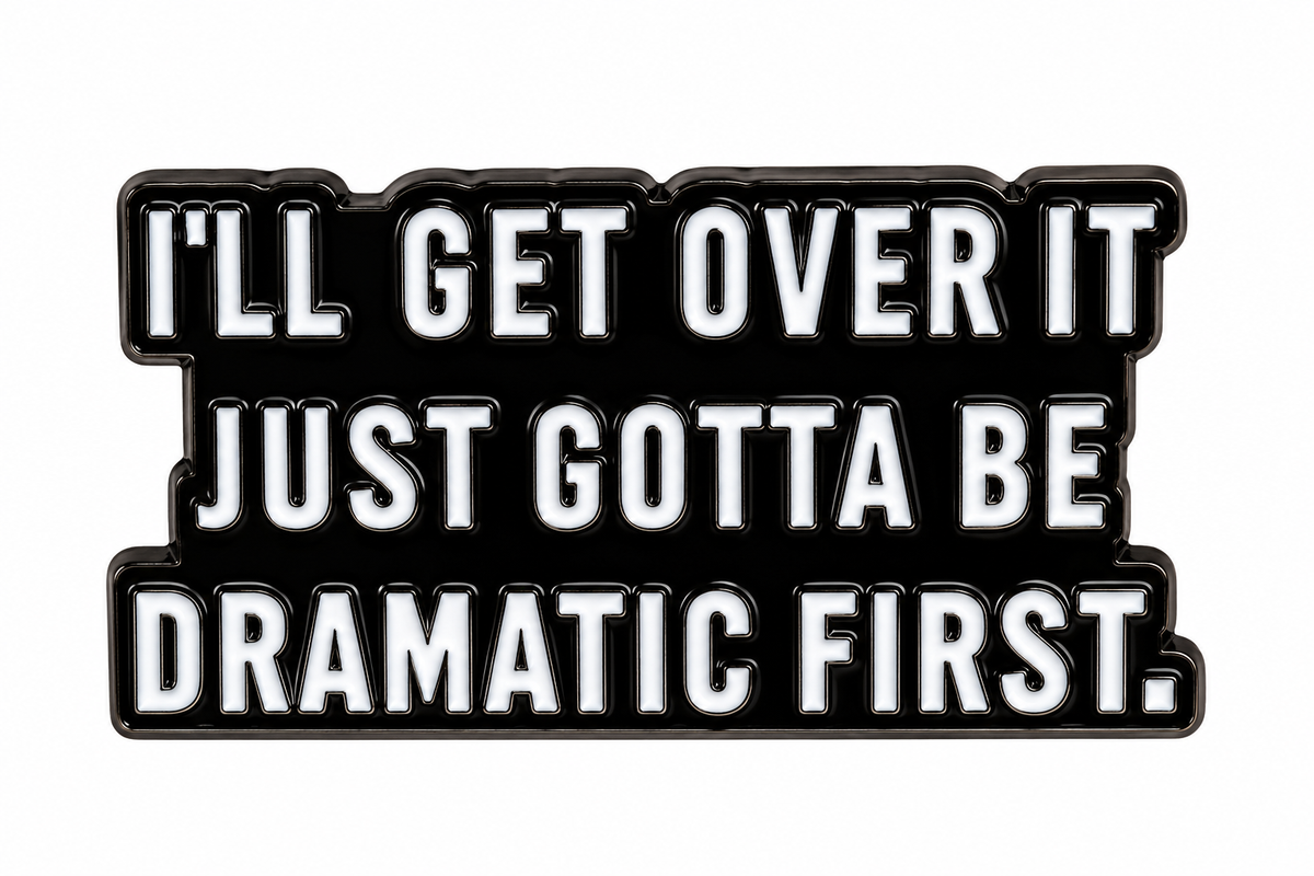 Dramatic First enamel metal pin on white background