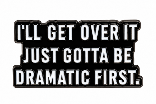 Dramatic First enamel metal pin on white background