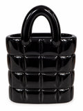 Glossy black quilted ceramic handbag vase on a clean white background