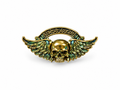Gold skull with wings alloy pin on white studio background, 4 cm