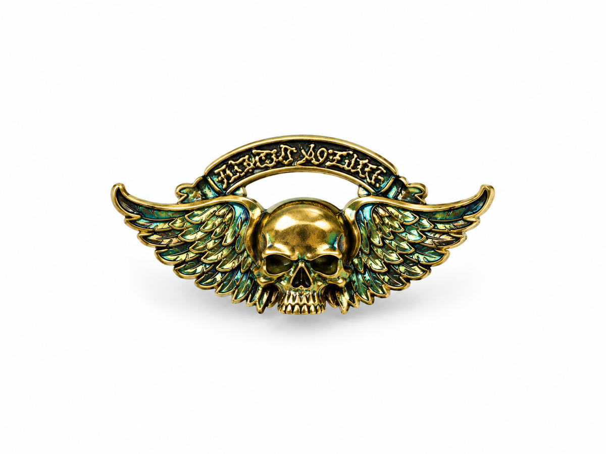 Gold skull with wings alloy pin on white studio background, 4 cm
