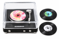 Miniature record player with three tiny vinyl records on white background