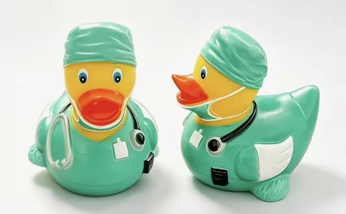 Resin surgeon doctor duck figurine in green scrubs with stethoscope
