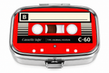 Retro red cassette tape mini pill box on white background