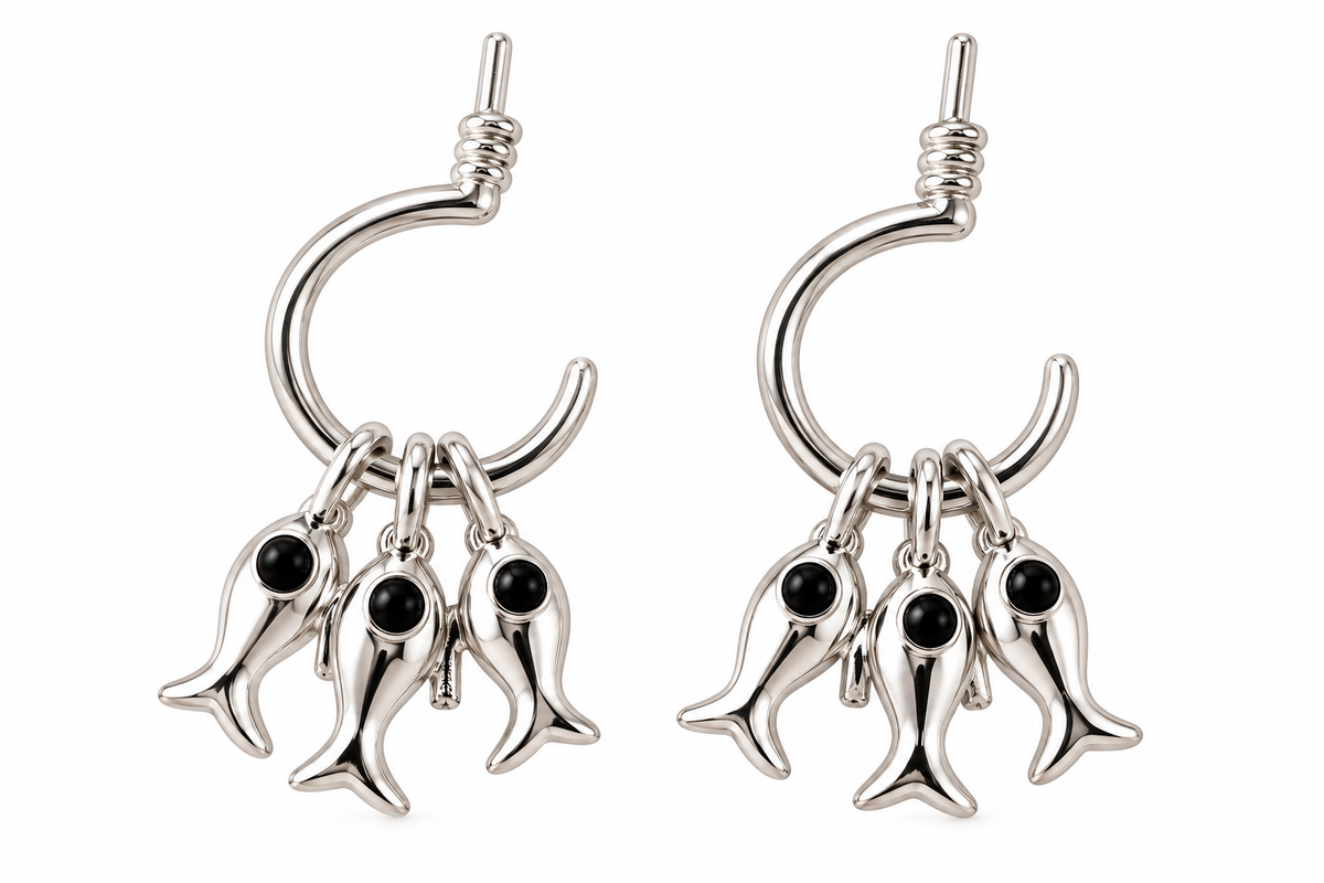 Silver-tone earrings with three dangling fish charms on each earring, white background